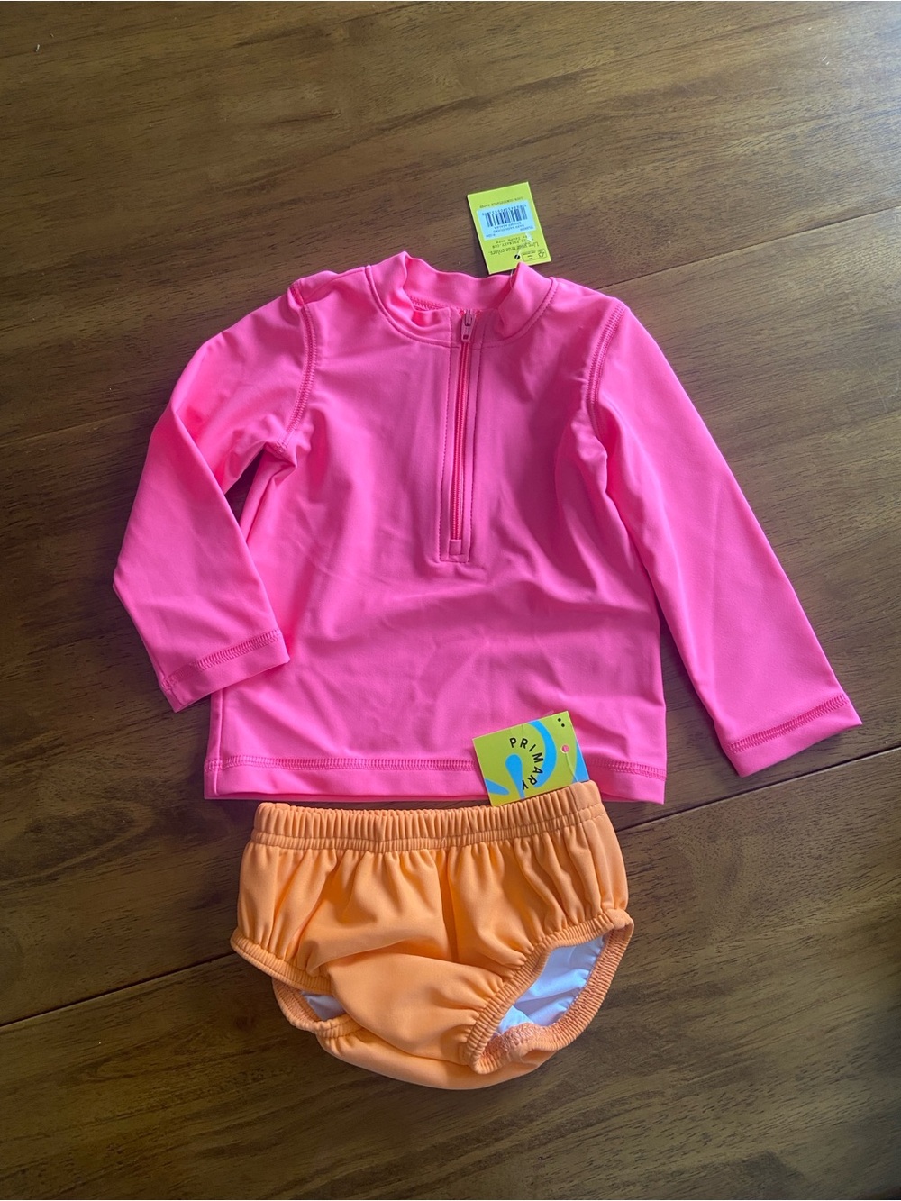 Primary Long-Sleeve Baby Rashguard with Orange Bottoms